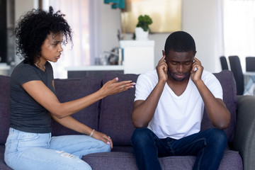 Indifferent black husband ignore pushy wife lecturing