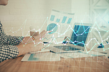 Double exposure of financial graph with man works in office on background. Concept of analysis.