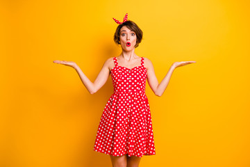 Portrait of astonished girl hold hand demonstrate incredible ads promotion impressed scream wow omg choose choice decide decision wear polka-dot skirt isolated over bright color background