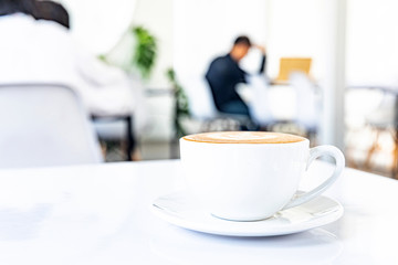 A cup of hot coffee latte on a white background at the coffee shop