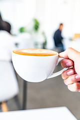 A young man with a hot coffee cup