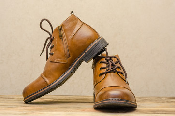 Brown leather men's shoes on a wooden background