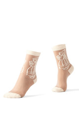 Cropped shot of female feet on tiptoe in the nylon transparent socks with a beige embroidering and...