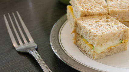 Some small sandwiches, served on a plate
