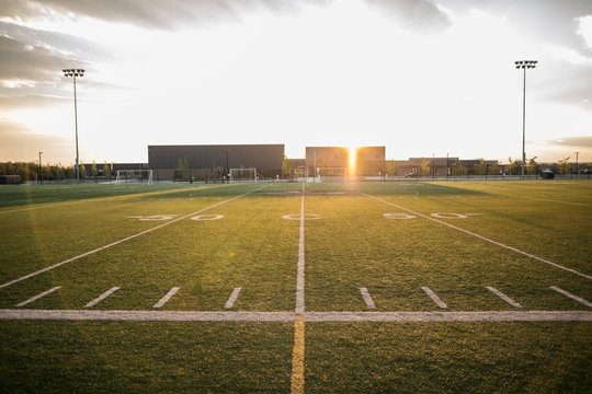 Sunny football field at sunset