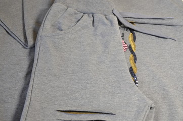 Children's knitted tracksuit for the girl in gray, stylish and comfortable for walking.