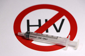 A syringe on the symbolic of anti HIV on white background.