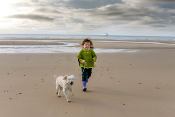 cute little girl sharing a tender moment with her little dog