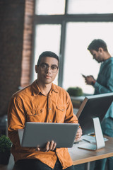 Fototapeta premium Intelligent handsome man having his laptop in hands