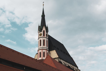 Fototapeta na wymiar Vintage image of the facade of St. Vitus Church in Cesky Krumlov, Czech Republic, during a sunny day