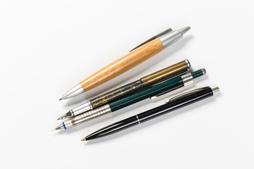 Collection of multi-colored ballpoint pens isolated on a white background