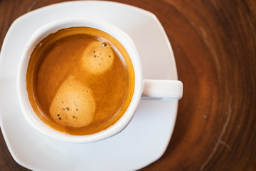 Hot coffee cup on wooden table