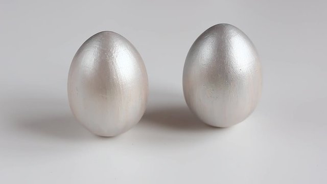 Easter eggs painted with silver paint on a white background. Easter holiday.