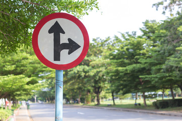 road sign in yellow background and black arrow