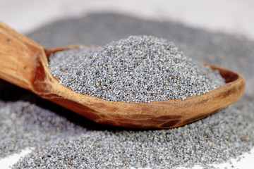 poppy seeds in a wooden spoon