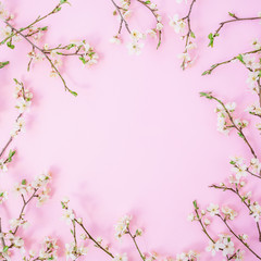Fototapeta na wymiar Floral frame with white spring flower isolated on pink background. Flat lay, top view