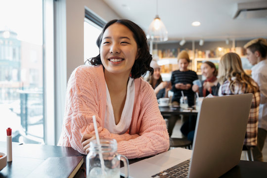 Smiling, Confident Korean High School Girl Student Studying At Laptop In Cafe