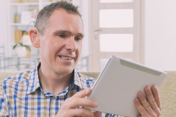 Deaf man using sign language on the tablet