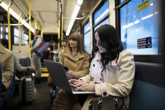 Businesswoman Commuter Working At Laptop On Bus