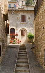 Fototapeta na wymiar A medieval picturesque street with staircase in Assisi, Italy