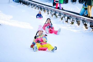 Fototapeta na wymiar Asian girls playing snow happily in japan. , Children playing in the snow , Children playing in the snow happily.Asian boy playing snow happily in japan.