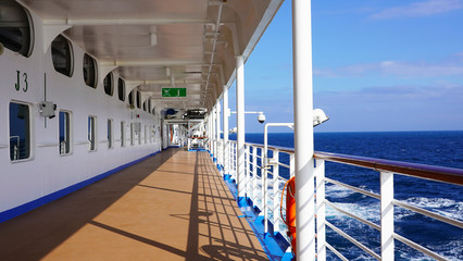 walk deck on a cruise ship. safety on the ship, lifeboat, liferafts, lifebuoys. liferaft station. blue ocean. white ship in the blue ocean. large cruise ship