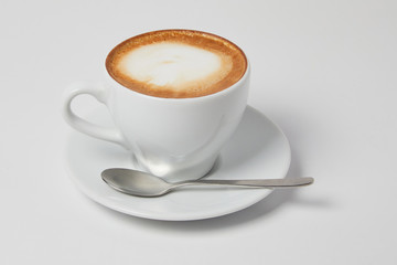 A cup of Cappuccino Latte coffee without a spoon on a white background. Ready for menu, studio shot