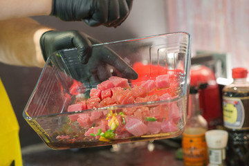 slicing fresh tuna on a wooden board