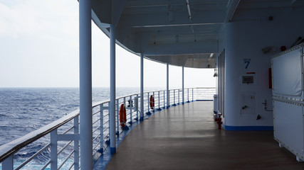 promenade deck on a cruise ship. safety on the ship, lifeboat, liferafts, lifebuoys. liferaft station. blue ocean. white ship in the blue ocean. large cruise ship   