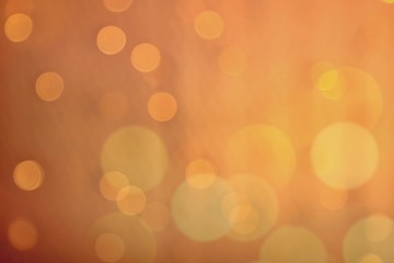 Romantic golden bokeh and orange background, Defocused light for festive holiday such as New year and Christmas background.