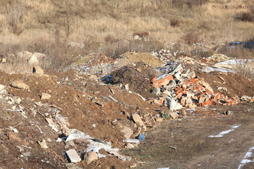 Construction waste with elements of various dismantled and destroyed old structures at municipal landfill