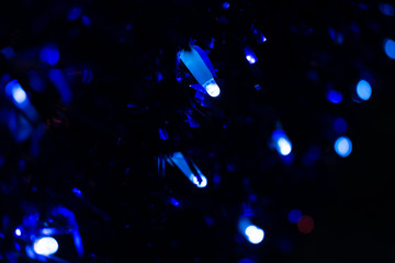 Abstract blur pattern of blue lights on isolated black background. Blue glitter texture christmas abstract backdrop. Christmas light.