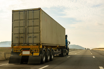 Cargo Truck on highway road with container, transportation concept.,import,export logistic industrial Transporting Land transport on the expressway againt sunrise sky