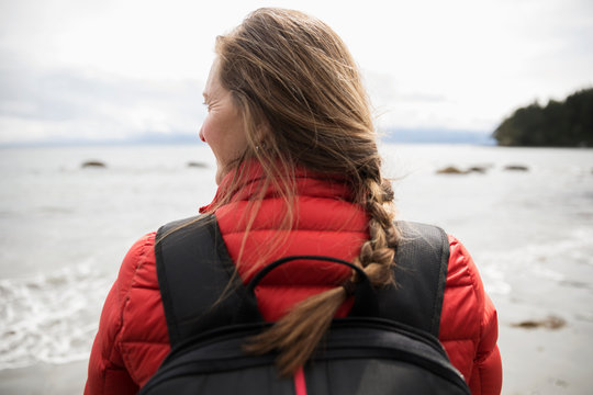 Woman backpacking on rugged beach