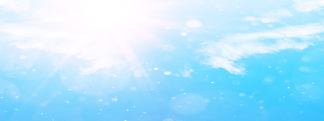 Fototapeta na wymiar snowflakes isolated on cloudy blue sky - winter background panorama banner long