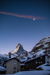 sunrise on Matterhorn with Alpenglow and moon in winter