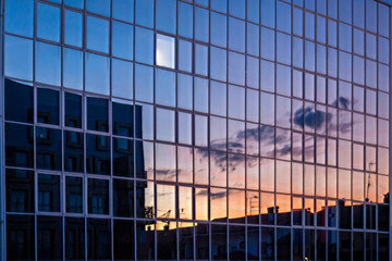 glass facade reflects the sunset