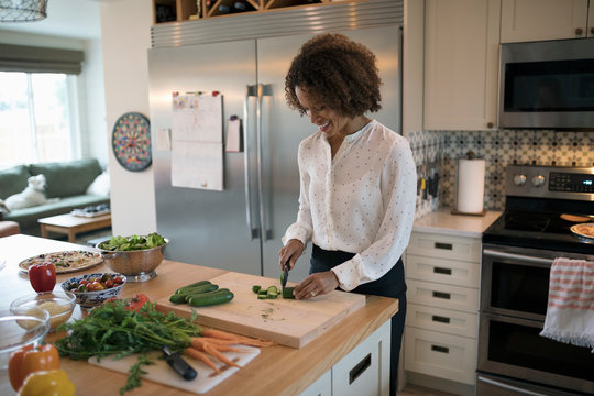 Woman Cooking, Cutting Vegetables In Kitchen