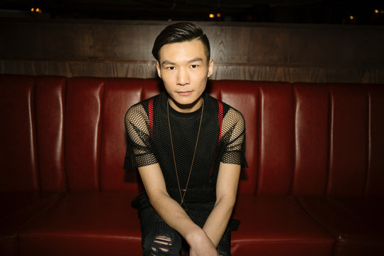 Portrait confident, cool male millennial in nightclub