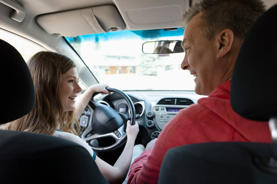 Father Teaching Tween Daughter How To Drive Car