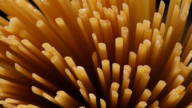 Spaghetti rotating on black background