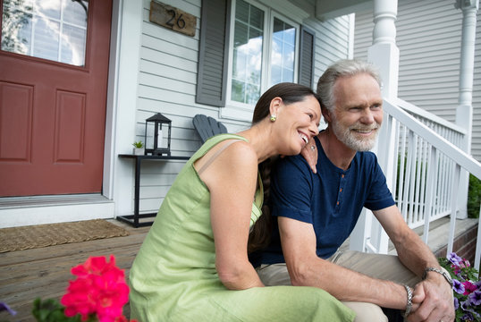 Affectionate senior couple relaxing on front stoop