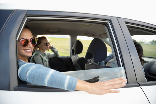 Smiling Young Women Friends In Car, Enjoying Road Trip