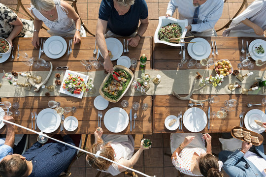 Overhead View Friends Enjoying Lunch And Wine At Patio Table