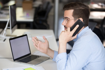 Male employee talk on phone with client or business partner