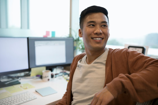 Smiling businessman looking away in office