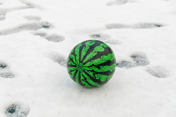 the ball looks like a watermelon on the snow