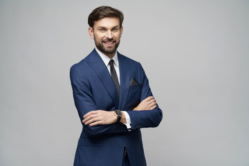 studio photo of young handsome stylish businessman wearing suit