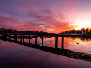 Fototapeta na wymiar Reflection on a lake during colorful sunset, stock image, Potsdam, Germany