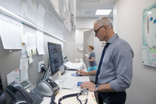 Male doctor using computer in clinic